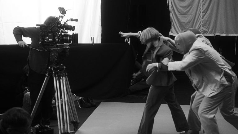 What happens when the architectural beats of The Chemical Brothers meet the ethereal folk-spirit of the North? Blend dives deep into the collaborative brain of Tom Rowlands, Aurora, and visual mastermind Adam Smith as they unveil their new entity: Tomora. By Blend Music Desk In the London underground, a "new beginning" usually smells of smoke and basement dust. But for Tomora, the start feels more like a fever dream. Their debut single, Ring The Alarm, isn't just a track—it’s a sensory overload, a "neon-tinged, otherworldly promo" that carries the frantic visual DNA we’ve come to expect from the legendary Adam Smith. The Visual Blueprint "Tom and Aurora started playing me stuff quite early on, and it was brilliant," Smith tells us. This wasn’t a standard client-director briefing; it was a creative riot. Smith reportedly flooded the duo with a mood board of 400 images. "Far too many," he admits with a grin. "But that’s the nature of this project. It’s been a total three-way collaboration. They picked the frames that spoke to the music, and we built the world from there." Beyond the "Geography" We’ve heard them together before—most notably on 2019’s No Geography—but Tomora is a different beast entirely. It’s the perfect marriage of Rowlands’ signature floor-shaking electronica and Aurora’s soaring, celestial vocals. It’s heavy, it’s haunting, and it’s unapologetically loud. The Coachella Whisper The hype has been simmering for months. Before the official reveal this week, Reddit was already in a meltdown following a cryptic "Tomora" slot on the 2026 Coachella line-up. The irony? The artists themselves were the last to know about the internet’s detective work. As the track drops, one thing is clear: Tomora isn't just a side project. It’s a structural evolution of the electronic landscape. SONIC ALCHEMY: Inside the neon-soaked world of TOMORA